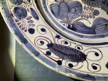 A blue, white and manganese Portuguese faience charger with a bird, 17th C.