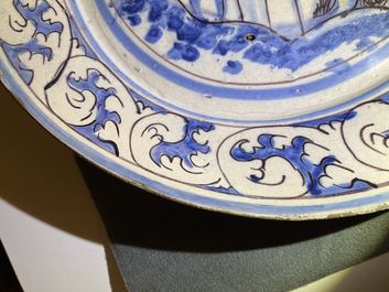 A blue, white and manganese Portuguese faience charger with a castle, 17th C.