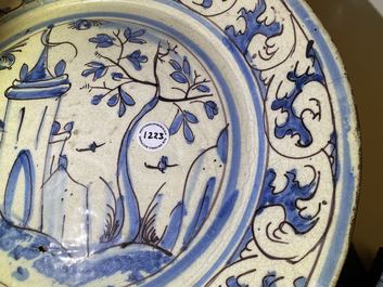 A blue, white and manganese Portuguese faience charger with a castle, 17th C.