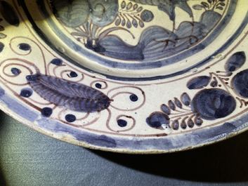 A blue, white and manganese Portuguese faience charger with a bird, 17th C.