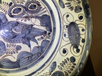 A blue, white and manganese Portuguese faience charger with a bird, 17th C.