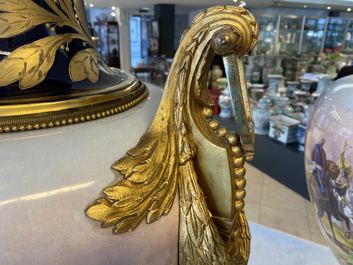 Une paire de tr&egrave;s grands vases en porcelaine dans le style de S&egrave;vres aux montures en bronze dor&eacute;, sign&eacute;s Desprez, France, 19&egrave;me