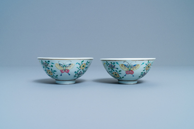 A pair of Chinese famille rose rice grain pattern 'butterfly' bowls, Qianlong mark, 19th C.