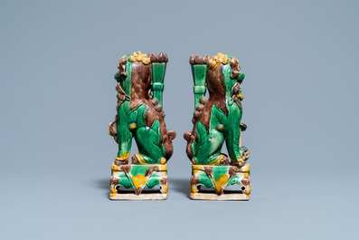 A pair of Chinese sancai-glazed biscuit Buddhist lion joss stick holders, Kangxi