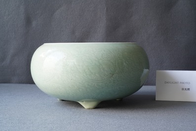 Een Chinese monochrome celadon driepotige wierookbrander met onderglazuur floraal decor, Kangxi