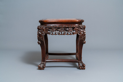 A Chinese carved wooden stand with marble top, 19th C.