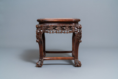 A Chinese carved wooden stand with marble top, 19th C.