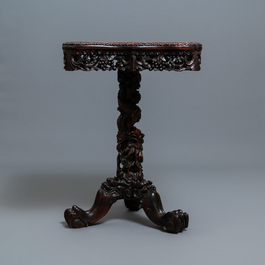 A Chinese carved wooden side table with marble chessboard top, 19th C.