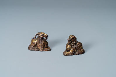 Two Chinese gilt and lacquered bronze 'mythical beast' scroll weights, late Ming