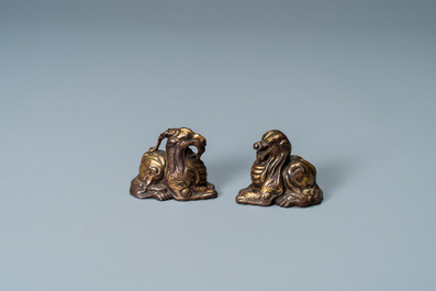 Two Chinese gilt and lacquered bronze 'mythical beast' scroll weights, late Ming