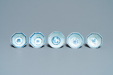 Sixteen Chinese blue and white saucers and fourteen cups, Kangxi