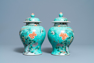 A pair of Chinese turquoise-ground famille verte vases and covers, 19th C.