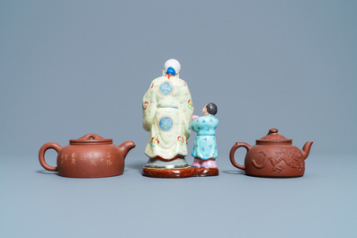 Two Chinese Yixing stoneware teapots and a famille rose 'Shou Lao' group, Kangxi and 20th C.
