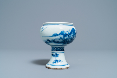 A Chinese blue and white stem cup with a continuous landscape scene, Kangxi/Yongzheng