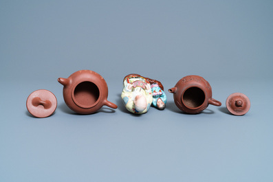 Two Chinese Yixing stoneware teapots and a famille rose 'Shou Lao' group, Kangxi and 20th C.