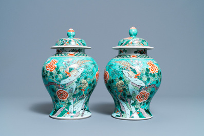 A pair of Chinese turquoise-ground famille verte vases and covers, 19th C.