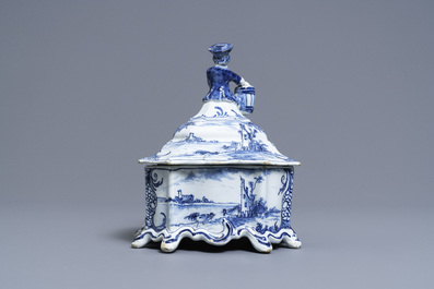 A Dutch Delft blue and white tobacco box and cover with a boy near a barrel, 18th C.