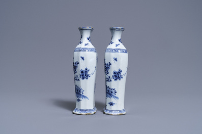 A pair of Dutch Delft blue and white vases and a 'peacock's tail' plate, 18th C.