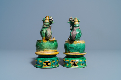 A pair of Chinese sancai-glazed biscuit Buddhist lion joss stick holders, Ming