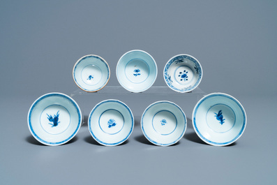 Eighteen Chinese blue and white saucers, seven cups, two dishes and a tea caddy, Kangxi/Qianlong