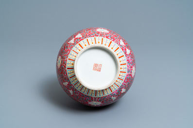 A Chinese famille rose ruby-ground bottle vase, Qianlong mark, 19/20th C.