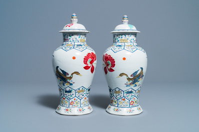 A pair of Chinese famille rose 'mandarin ducks' vases and covers, Kangxi mark, Republic