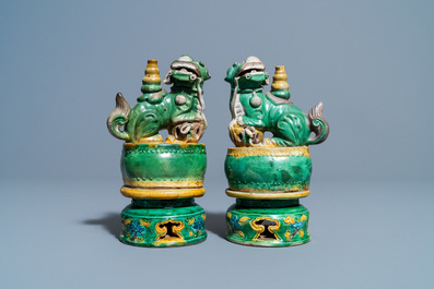 A pair of Chinese sancai-glazed biscuit Buddhist lion joss stick holders, Ming