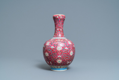 A Chinese famille rose ruby-ground bottle vase, Qianlong mark, 19/20th C.