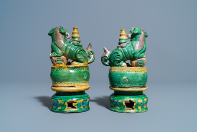 A pair of Chinese sancai-glazed biscuit Buddhist lion joss stick holders, Ming