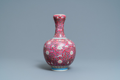 A Chinese famille rose ruby-ground bottle vase, Qianlong mark, 19/20th C.