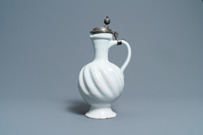 A large gadrooned white Dutch Delftware jug with pewter cover, 17th C.