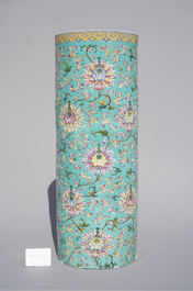 A large Chinese famille rose cylindrical vase with molded lotus scrolls, Jiaqing/Daoguang