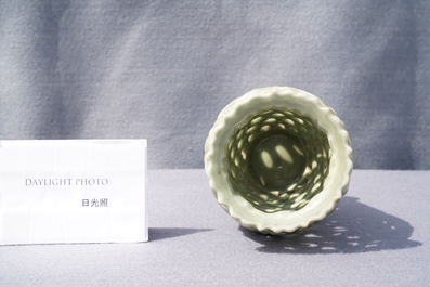 A Chinese reticulated monochrome Longquan celadon brush pot, Ming