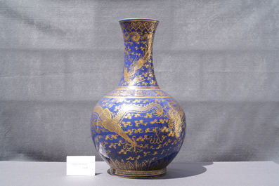 A large Chinese monochrome blue gilt-decorated 'dragon and phoenix' bottle vase, Guangxu mark and of the period