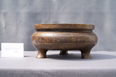 A Chinese parcel-gilt bronze tripod censer, Xuande merk, Qing