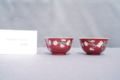 A pair of Chinese famille rose ruby-ground cups and saucers, Yongzheng