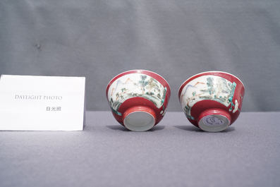 A pair of Chinese famille rose ruby-ground cups and saucers, Yongzheng