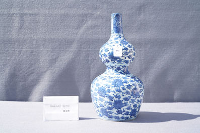 A Chinese blue and white 'lotus scroll' double gourd vase, Wanli