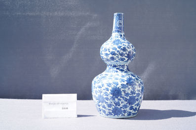 A Chinese blue and white 'lotus scroll' double gourd vase, Wanli