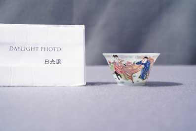 A Chinese famille rose 'tea scene' cup and saucer, Yongzheng/Qianlong