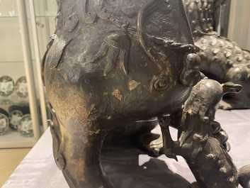 A pair of large Chinese bronze models of Buddhist lions, Ming