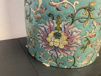 A large Chinese famille rose cylindrical vase with molded lotus scrolls, Jiaqing/Daoguang