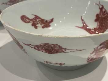 A pair of Chinese copper-red 'dragons and carps' bowls, Kangxi/Qianlong