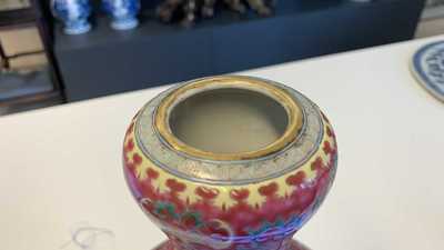 A Chinese famille rose ruby-ground bottle vase, Qianlong mark, 19/20th C.