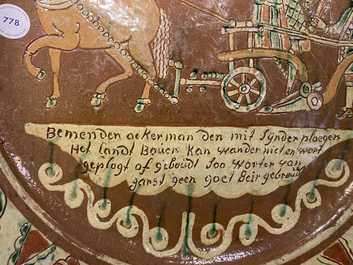 A German slip-decorated inscribed pottery dish with a ploughing farmer, Lower Rhine region, 2nd half 18th C.