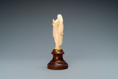 An ivory figure of a woman dressed after the antique holding a vase, probably Dieppe, France, 19th C.