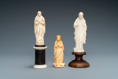 Two figures of Madonna and one of Christ in ivory and bone, 19th C.