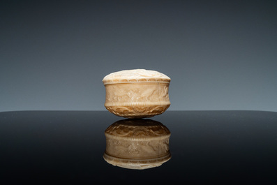 An ivory box and cover with a boy sitting by a water well, 18th C.