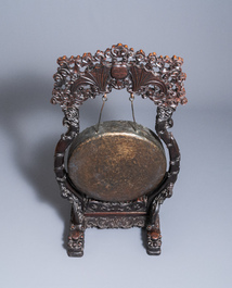 A Chinese bronze gong set in a carved wooden stand, 19th C.