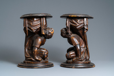 A pair of patinated coniferous wood candle supports in the shape of kneeling Moors, Venice, Italy, 17/18th C.
